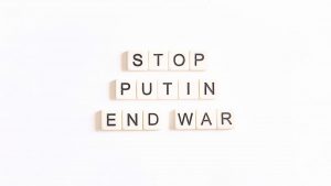 scrabble letters spelling the word stop, put in end war