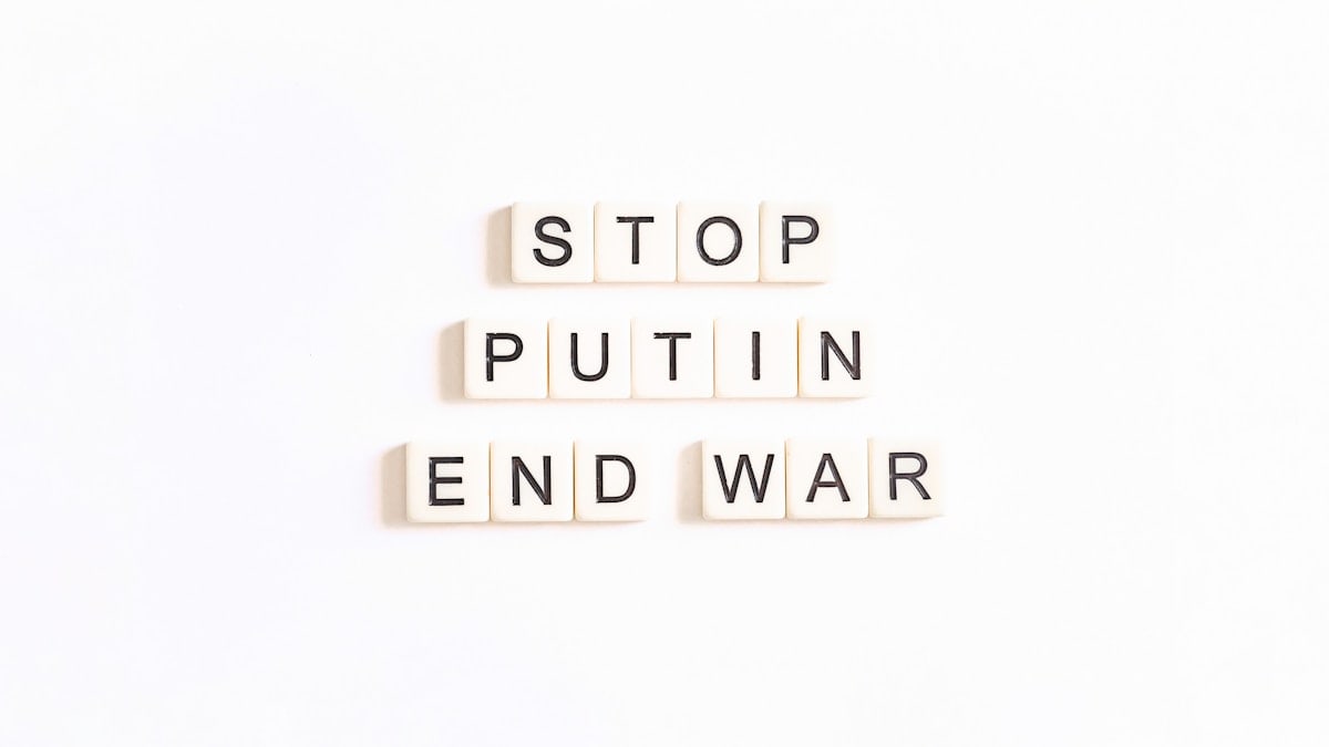 scrabble letters spelling the word stop, put in end war